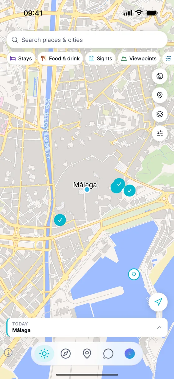 The map in the app with category filters and saved places around Málaga.